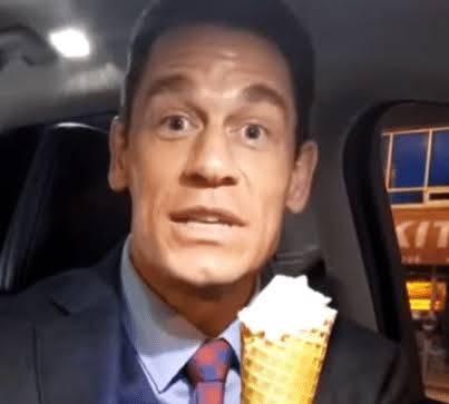 John Cena holds an ice cream and says 'bing chilling' (Chinese).